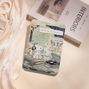 May include: A white ceramic mug with a black handle and the text "But First, Coffee" in a black, bold font. The mug is sitting on a wooden surface. The mug is 4 inches tall.