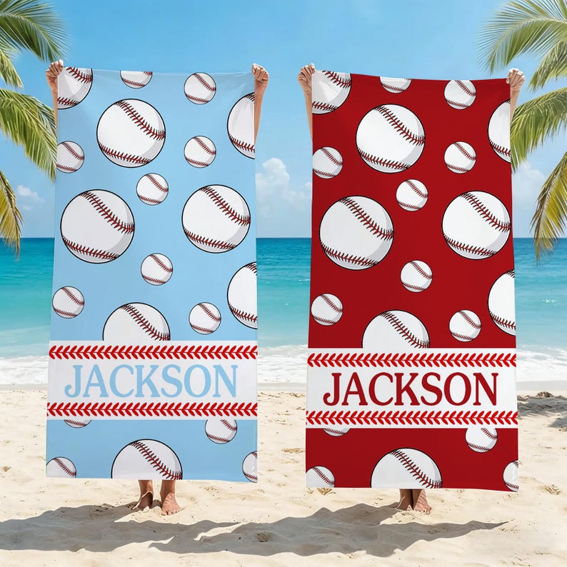 May include: Two beach towels with baseball designs. One is light blue with white baseballs and the name "JACKSON" in blue. The other is red with white baseballs and the name "JACKSON" in white.