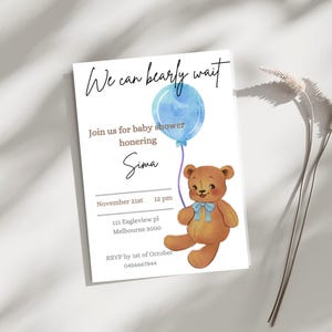 May include: Baby shower invitation with a watercolor illustration of a teddy bear holding a blue balloon. The invitation reads "We can bearly wait" and includes details for the event, such as the date, time, and location.