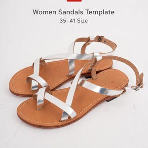 May include: A pair of silver sandals with brown leather soles. The sandals have multiple straps and buckles. The text "Women Sandals Template 35-41 Size" is visible in the image.