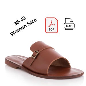 May include: Brown leather sandal with a buckle closure. The sandal has a simple design with a single strap across the top and a flat sole. The text "35-43 Women Size" is in the upper left corner.