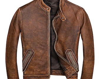 May include: A brown leather jacket with a stand-up collar and a zip-up front. The jacket has two zippered pockets and a distressed finish, giving it a vintage look. The jacket is a classic style.