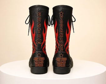May include: A pair of black mid-calf boots featuring red flame graphics and text. The left boot displays the word CUSTOM, and the right boot displays YOUR NAME. Both boots feature a star icon and the text ADD YOUR NAME HERE at the base.