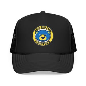 May include: A black trucker hat featuring a circular graphic on the front panel. The graphic displays a blue bear face with yellow accents inside a yellow ring, surrounded by the text KEEP OUR PACK TOGETHER in bold blue capital letters.