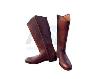 May include: A pair of tall, burgundy leather riding boots. One boot has a zipper running along the side. The boots are designed for equestrian activities and have a classic, streamlined appearance.