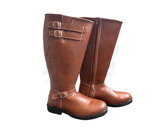 May include: A pair of brown leather riding boots with double buckles and a zipper on the side.