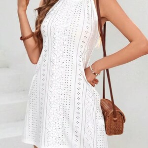 resort wear mini dress, beach vacation outfit, white halter dress, summer fashion dress, casual chic dress, feminine summer outfit, breathable cotton dress, stylish mini dress, vacation ready dress, boho beach outfit, elegant summer mini dress, trendy fashion piece, lightweight holiday dress