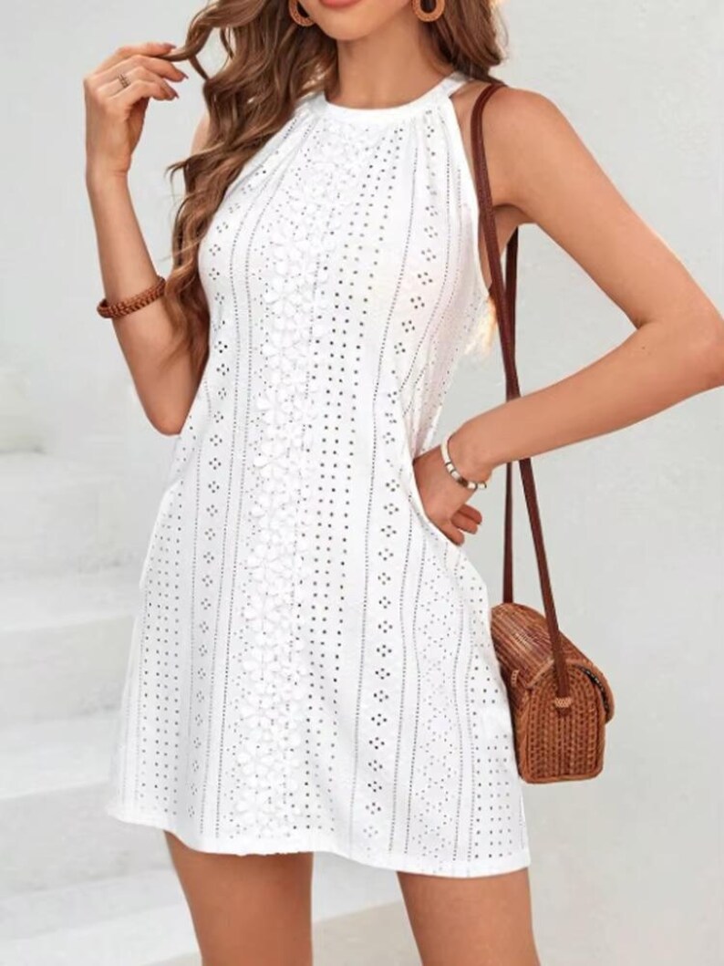 resort wear mini dress, beach vacation outfit, white halter dress, summer fashion dress, casual chic dress, feminine summer outfit, breathable cotton dress, stylish mini dress, vacation ready dress, boho beach outfit, elegant summer mini dress, trendy fashion piece, lightweight holiday dress