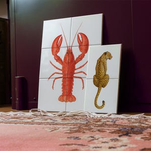 May include: White square tiles featuring illustrations of a red lobster and a leopard. The lobster is on four tiles, the leopard on two. The leopard is yellow with black spots, creating a striking contrast.