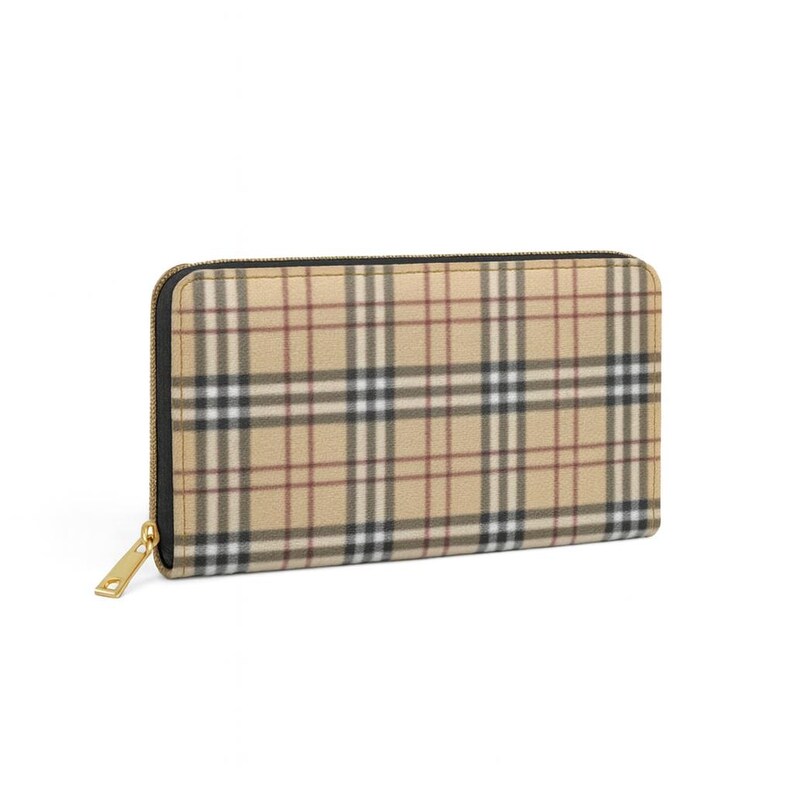 May include: A beige and plaid zip-around wallet with a gold-toned zipper pull. The wallet features a classic plaid pattern in beige, black, and red. The wallet is rectangular in shape.