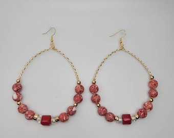 Wire wrapped gold wite hoops with red and white marble style beads