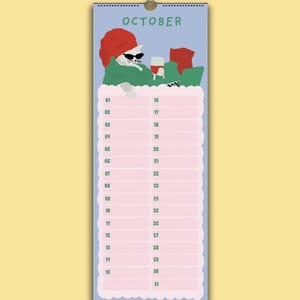 May include: A vertical wall calendar page for October featuring a light blue background and a white cat wearing black sunglasses and a red towel on its head. The cat is relaxing in a green sweater with a glass of red wine. Below are pink date rows.