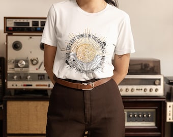 The Light Shines In The Darkness Unisex Jersey Short Sleeve Tee