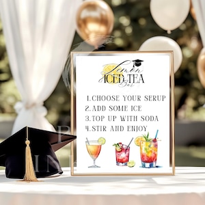 May include: A framed sign for a Lemon Iced Tea Bar with instructions and illustrations of cocktails. The sign includes a graduation cap graphic and the text "Lemon Iced Tea Bar". A graduation cap with a gold tassel is on the left.