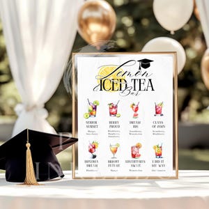 May include: A framed sign for a Lemon Iced Tea Bar, featuring a graduation cap illustration. The sign displays colorful watercolor illustrations of various iced tea cocktails with names like "Senior Sunset" and "Class of 2025."