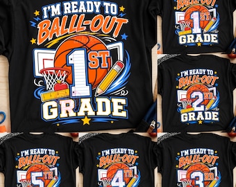 May include: A black t-shirt featuring a graphic design with the text I'M READY TO BALLL-OUT and GRADE. The design includes a basketball, a basketball hoop, a yellow pencil, a ruler, an apple, and a large number representing the grade level.