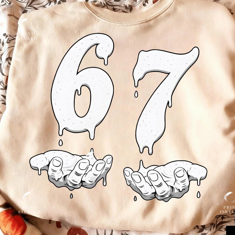 May include: Cream-colored sweatshirt featuring the number "67" in a dripping, white design. Below the numbers are two hands, also in white, appearing to catch the dripping substance. The design is a graphic illustration.