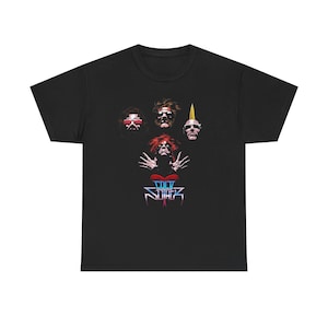 May include: Black t-shirt with a graphic design featuring four stylized faces and the text "COCO SUFFER" in a blue and red font. The faces have different hairstyles and accessories.