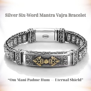 May include: Silver Six-Word Mantra Vajra bracelet with intricate detailing. The bracelet features a central gold-colored design and is inscribed with the mantra "Om Mani Padme Hum - Eternal Shield". The bracelet is made of silver.