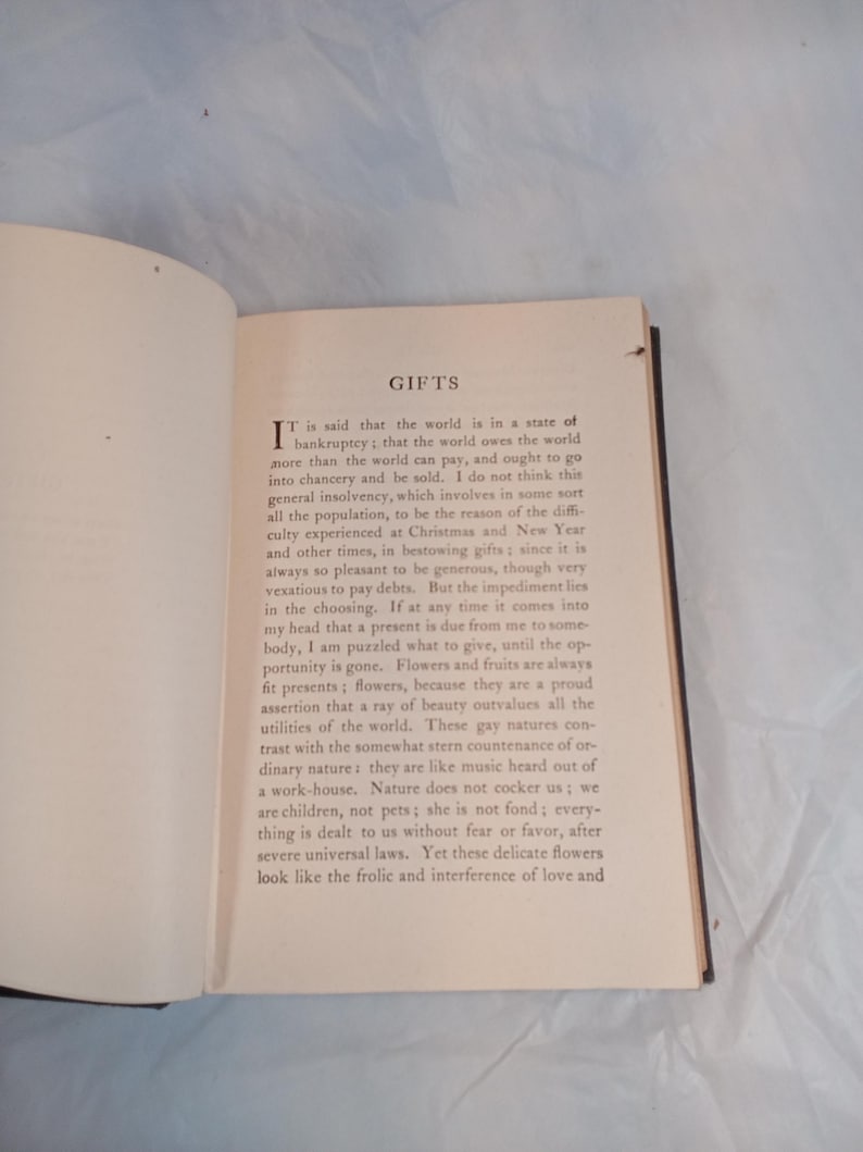 May include: An open book with text on aged paper. The title "GIFTS" is at the top of the page. The text is in black ink, with a large initial letter at the beginning of the first paragraph. The book's pages are yellowed.