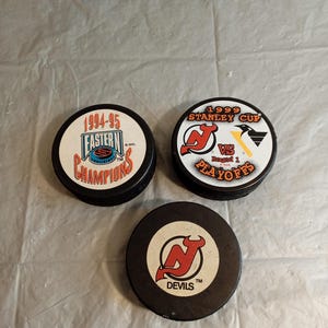 3 Official NJ Devils Hockey Pucks, New Jersey Devils, 1999 Stanley Cup Hockey Puck, 1994-95 Hockey Puck