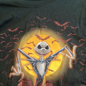 May include: A white ceramic mug with a black handle and the text "But First, Coffee" in a handwritten style. The mug is on a white surface. The mug is likely used for hot beverages.