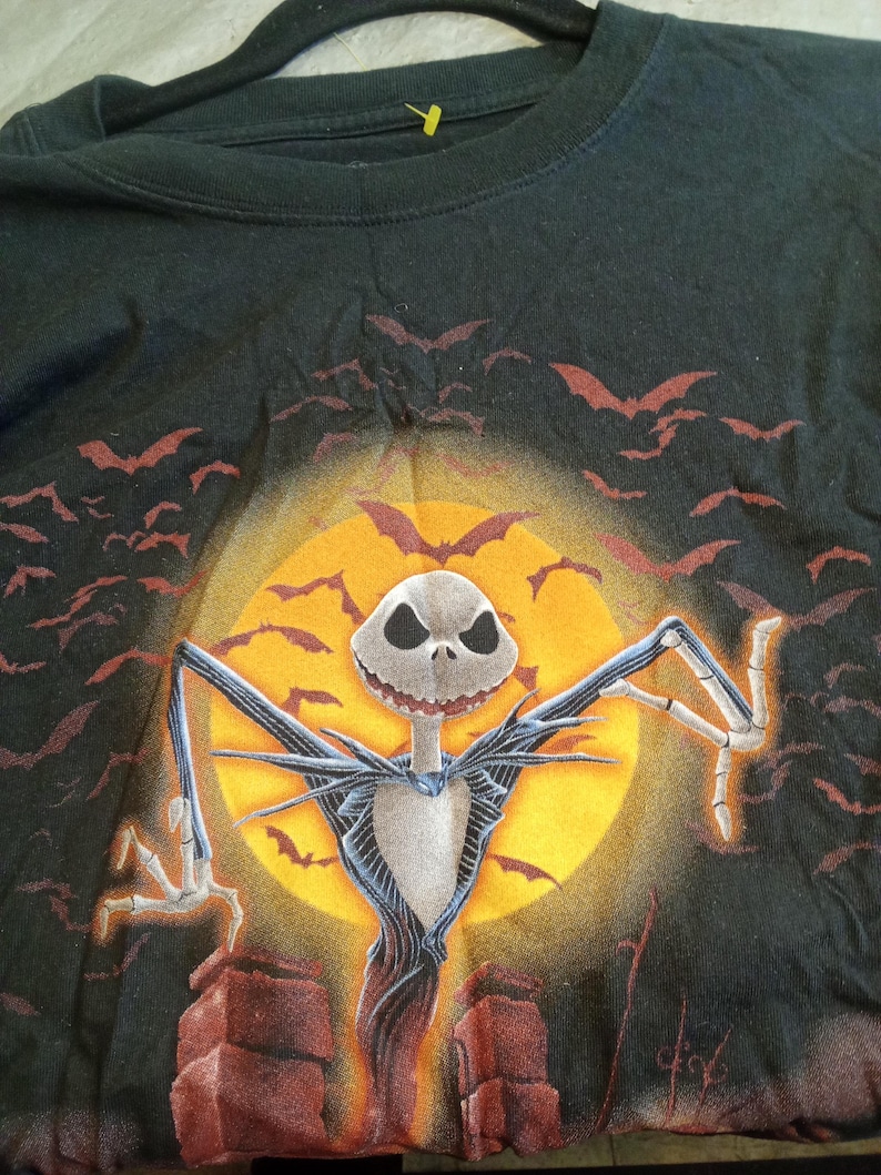 May include: A white ceramic mug with a black handle and the text "But First, Coffee" in a handwritten style. The mug is on a white surface. The mug is likely used for hot beverages.