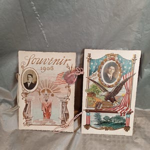 May include: Two vintage souvenir postcards. The left card reads "Souvenir 1906" and features a portrait, a statue, and an American flag. The right card has a portrait, an eagle, and an American flag. Both cards have decorative borders.