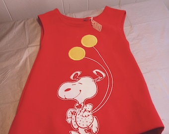 May include: Red sleeveless dress with a white graphic of Snoopy holding balloons. The balloons are yellow.