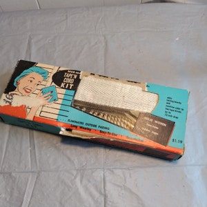 May include: A box of Mur-Ma Tape'n Cord Kit for window blinds. The box features a woman holding a white tape and cord. The box is red, white, and blue with the text "Mur-Ma Tape'n Cord Kit" and "Eliminates Outside Fading". The box also includes the text "Solid Woven Two-Tone Ladder Tape" and "$1.19".