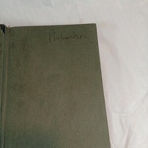 May include: Open book with a green cover. The handwritten name "Richardson" is visible on the cover. The book is set against a white background.