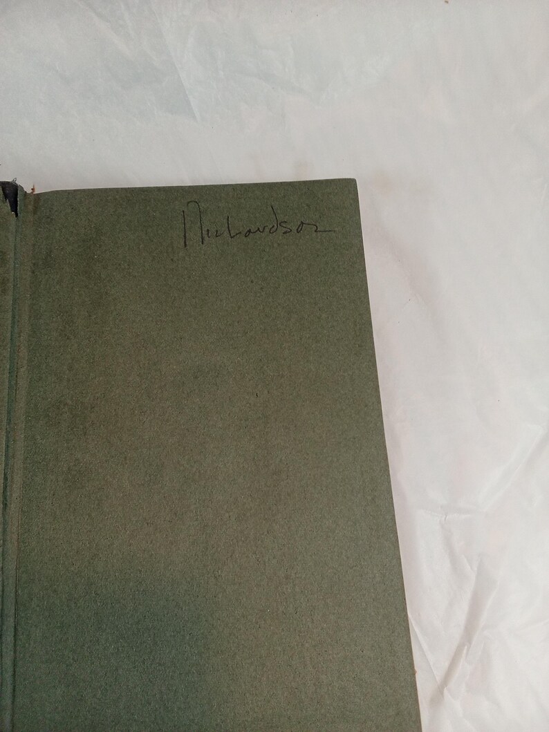 May include: Open book with a green cover. The handwritten name "Richardson" is visible on the cover. The book is set against a white background.