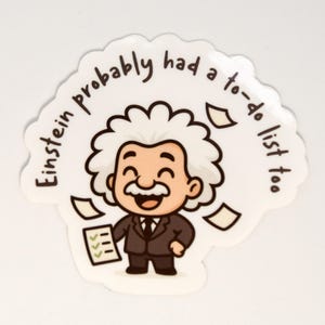 Può includere: Un adesivo bianco con un'illustrazione a cartone animato di Albert Einstein sorridente e con una lista di cose da fare. Il testo "Einstein probably had a to-do list too" circonda l'immagine.