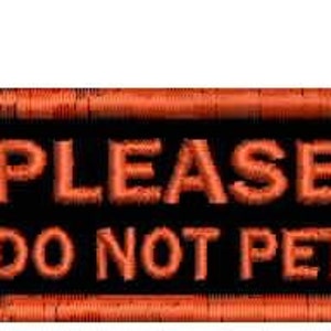 May include: Embroidered patch with the words "PLEASE DO NOT PET" in orange block letters on a black background. The patch has an orange border.