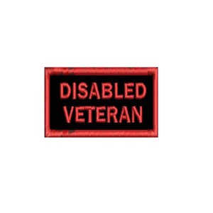 May include: A rectangular patch with a black background and a red border. The words "DISABLED VETERAN" are embroidered in red, bold capital letters. The patch has a slightly distressed, worn appearance.