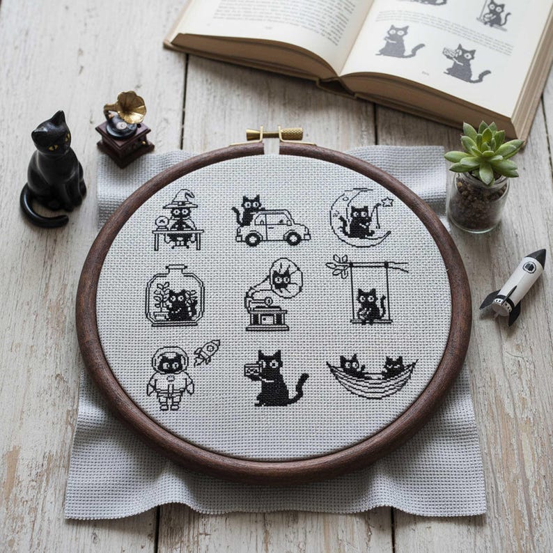 This fantasy cross-stitch pattern features a hobbit-style cottage illustrated across all four seasons, each framed within a decorative postage stamp border. Spring blooms with soft flowers and gentle sunlight, summer glows with lush greenery, autumn warms the scene with golden leaves, and winter settles into a peaceful snowfall beneath a glowing moon. The rounded door, grassy roof, and winding path tie each scene together, creating a cohesive yet varied seasonal collection.