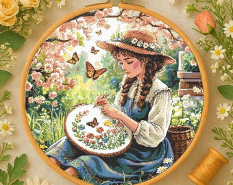 May include: A cross-stitch pattern featuring a young woman with long brown hair, wearing a straw hat and a blue dress, sitting in a garden setting with butterflies and flowers. She is holding a needle and thread, working on a cross-stitch project.