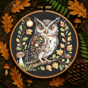 This richly detailed owl design brings autumn to life with its woodland elements and earthy palette. Acorns rest on the owl’s wing, framed by golden foliage, mushrooms, and a glowing lantern. With 13,266 stitches in black and subtle tones like Apple Green, Rosewood, and Driftwood, this 145 x 145 stitch project makes a thoughtful handmade gift or seasonal home decor piece. Perfect for fall and Halloween embroidery projects.