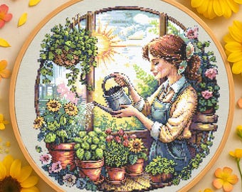 May include: A cross-stitch embroidery pattern featuring a woman watering plants in a sunny window. The woman is wearing a blue and yellow dress and holding a watering can. The plants are in pots and include sunflowers, ferns, and other greenery.