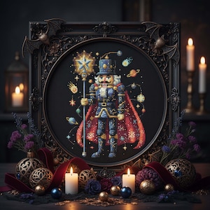 May include: A cross-stitch picture of a nutcracker soldier in a decorative frame. The soldier is in a blue uniform and red cape, holding a star-topped staff. The frame has bat and floral details, with candles and baubles in the foreground.