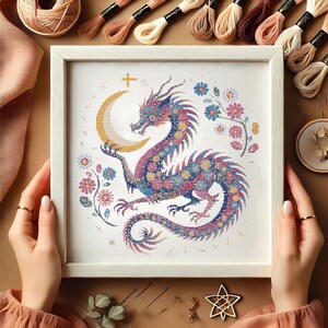 Majestic Floral Dragon Cross-Stitch Pattern – Instant Download
This exquisite dragon cross-stitch pattern blends fantasy and floral elements, featuring a beautifully detailed mythical dragon coiled around a glowing crescent moon. Perfect for embroidery lovers who enjoy celestial and magical designs, this PDF pattern is a must-have for creative projects.