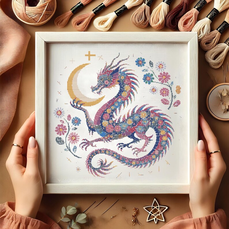 Majestic Floral Dragon Cross-Stitch Pattern – Instant Download
This exquisite dragon cross-stitch pattern blends fantasy and floral elements, featuring a beautifully detailed mythical dragon coiled around a glowing crescent moon. Perfect for embroidery lovers who enjoy celestial and magical designs, this PDF pattern is a must-have for creative projects.