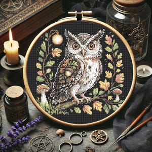 This richly detailed owl design brings autumn to life with its woodland elements and earthy palette. Acorns rest on the owl’s wing, framed by golden foliage, mushrooms, and a glowing lantern. With 13,266 stitches in black and subtle tones like Apple Green, Rosewood, and Driftwood, this 145 x 145 stitch project makes a thoughtful handmade gift or seasonal home decor piece. Perfect for fall and Halloween embroidery projects.