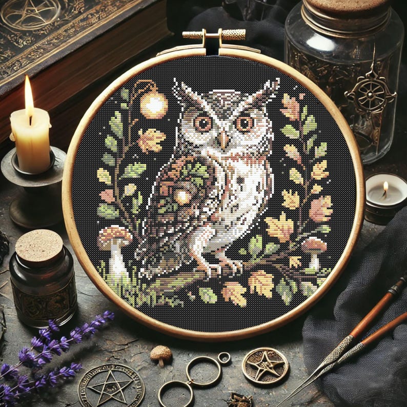 This richly detailed owl design brings autumn to life with its woodland elements and earthy palette. Acorns rest on the owl’s wing, framed by golden foliage, mushrooms, and a glowing lantern. With 13,266 stitches in black and subtle tones like Apple Green, Rosewood, and Driftwood, this 145 x 145 stitch project makes a thoughtful handmade gift or seasonal home decor piece. Perfect for fall and Halloween embroidery projects.