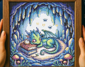 May include: Cross-stitch artwork of a sleeping baby dragon in a cave. The dragon is green and blue, resting on a bed of moss next to books and a clock. The cave is blue with stalactites and mushrooms.