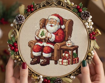 Santa Stitching Cross Stitch Pattern: Cozy Christmas Embroidery PDF with Santa Sewing a Tree and Gifts