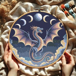 Mystical Lunar Dragon Embroidery Chart – DIY Fantasy Needlework
Immerse yourself in a world of cosmic wonder with this stunning celestial dragon embroidery pattern. With intricate shading, glowing moon phases, and a powerful dragon silhouette, this PDF cross-stitch chart is ideal for fantasy-inspired stitching and unique home decor.