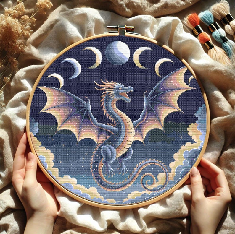 Mystical Lunar Dragon Embroidery Chart – DIY Fantasy Needlework
Immerse yourself in a world of cosmic wonder with this stunning celestial dragon embroidery pattern. With intricate shading, glowing moon phases, and a powerful dragon silhouette, this PDF cross-stitch chart is ideal for fantasy-inspired stitching and unique home decor.