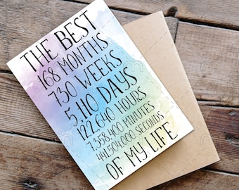 May include: A card with a watercolor background in shades of blue, green, yellow, and pink. The card features the text "THE BEST 168 MONTHS 730 WEEKS 5,110 DAYS 122,640 HOURS 7,358,400 MINUTES 441,504,000 SECONDS OF MY LIFE".
