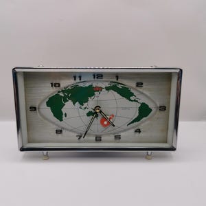 May include: A set of three ceramic canisters with lids. The canisters are white with a blue floral pattern. The largest canister is 8 inches tall, the medium is 6 inches, and the smallest is 4 inches.